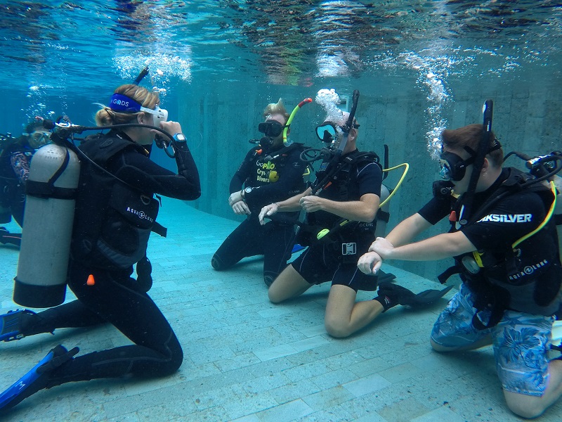 A group of divers practicing their diving skills