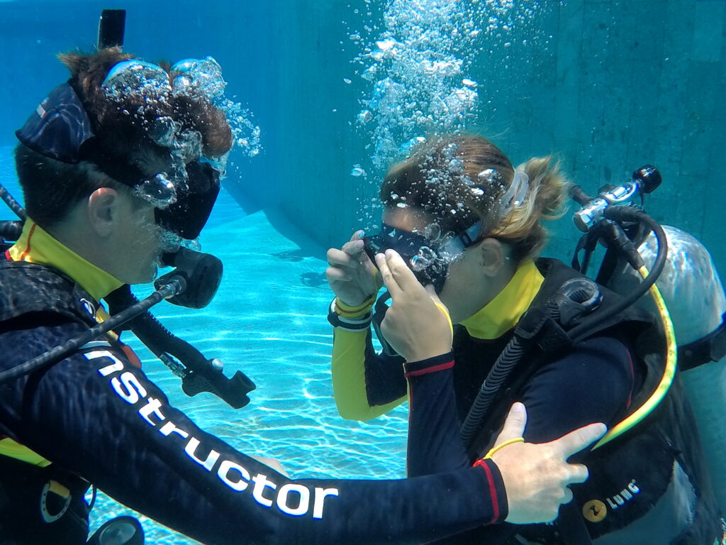 Two divers going over refresher scuba skills